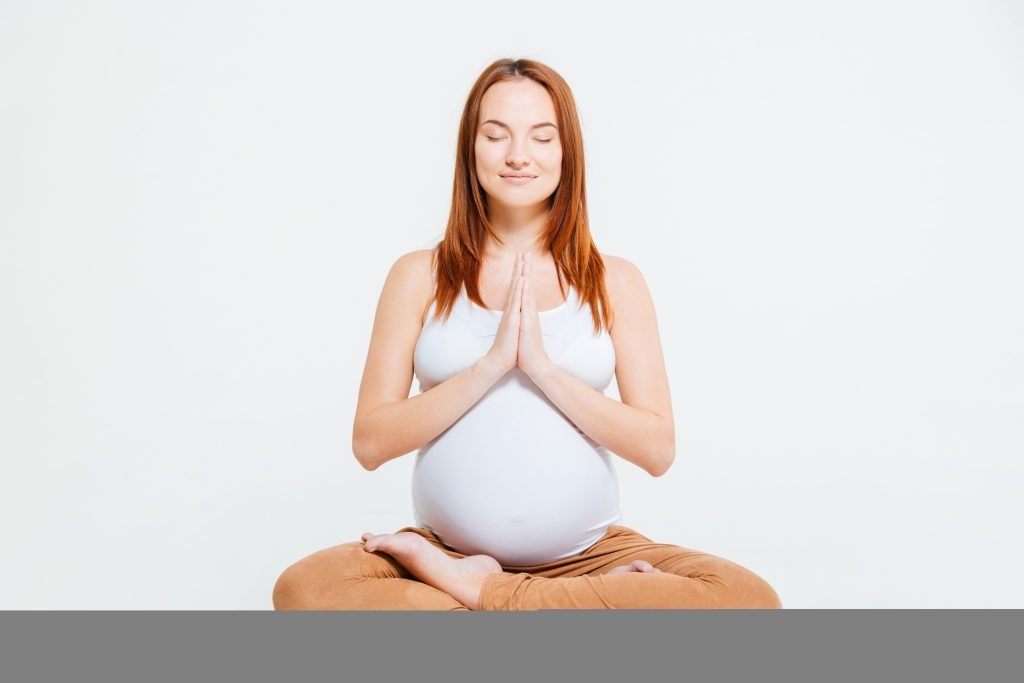 Relaxed pregnant woman meditating